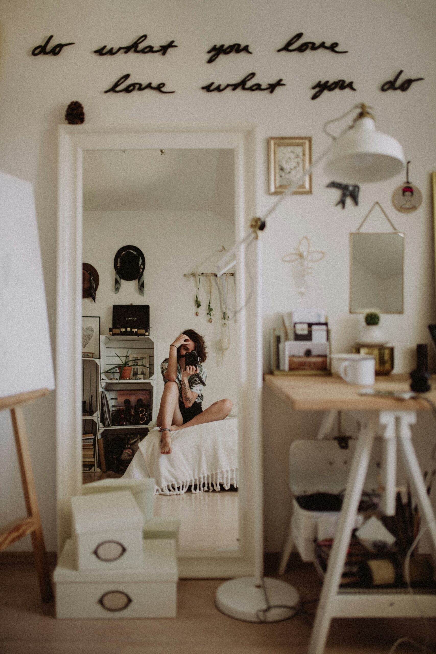 woman photographing herself in the mirror